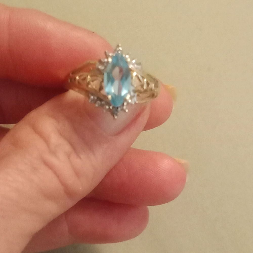 Avon 10 k natural ice blue topaz and diamond ring. Size 7.75